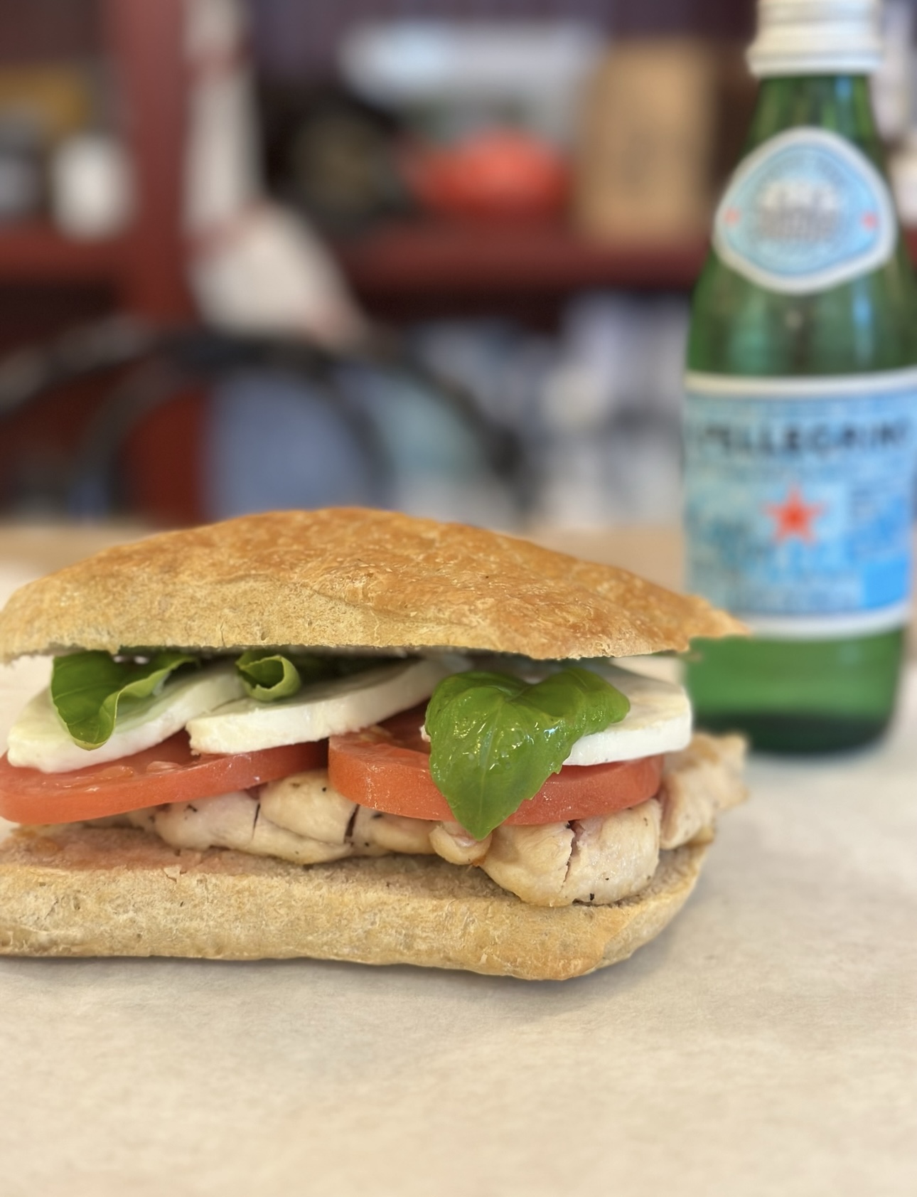 A fresh chicken, tomato, mozzarella and basil sandwich from Milk House Market